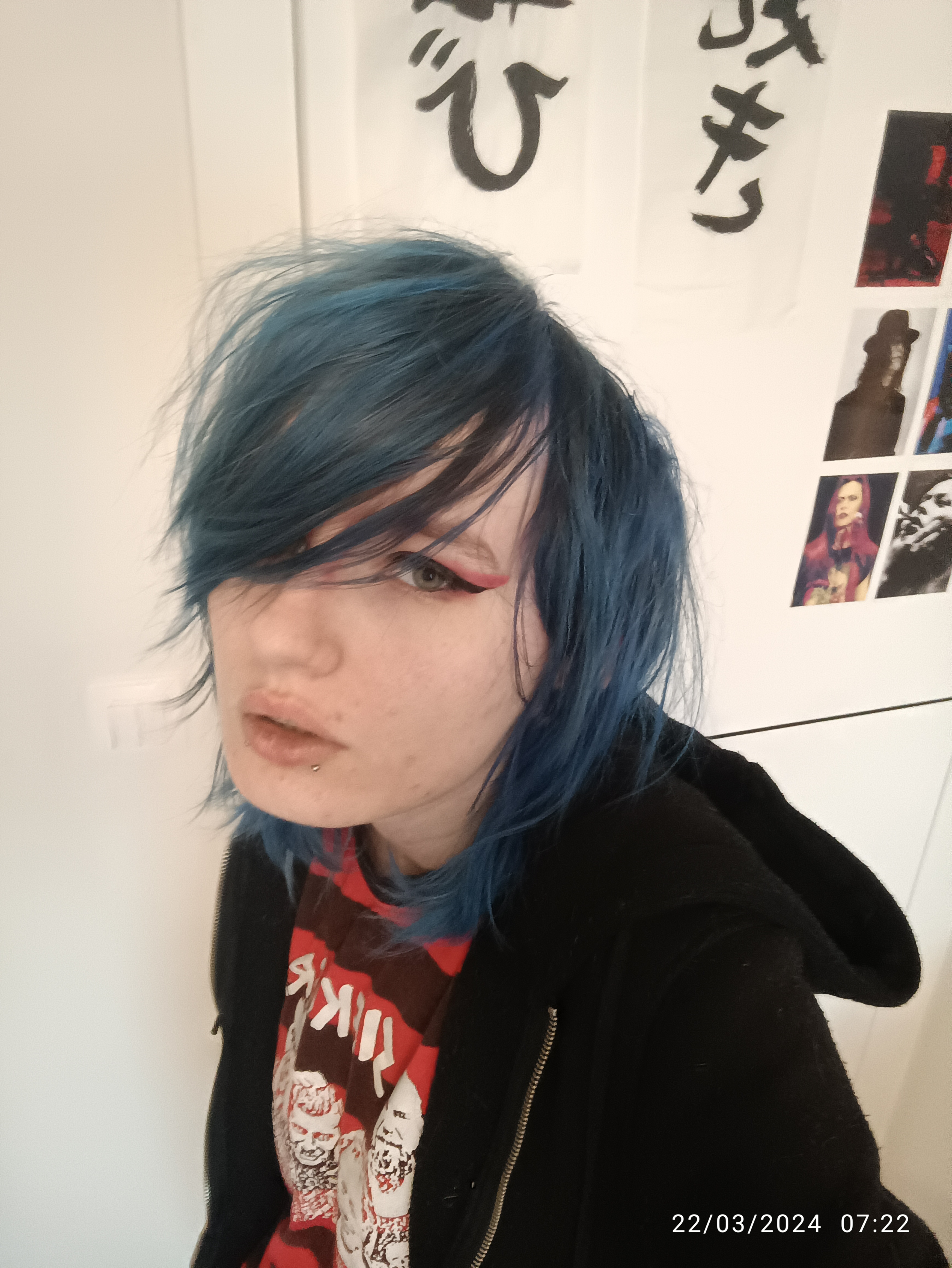 a photo of Ray, a white person with blue hair